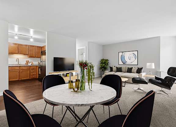 A modern living room with a dining table and chairs.