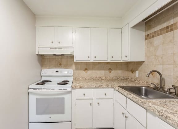 a white kitchen with white appliances and white cabinets at Stonebridge, Ellington, Connecticut