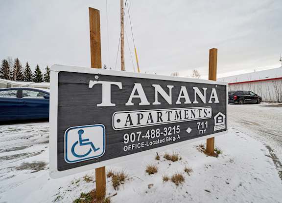 Tanana Apartments sign with a phone number and a wheelchair symbol.