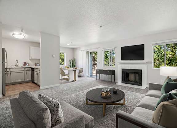 A modern living room with a grey couch and a coffee table.