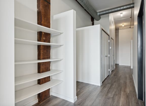 a walk in closet with white walls and wooden shelvesat Gaar Scott Historic Lofts, Minneapolis, MN, 55401