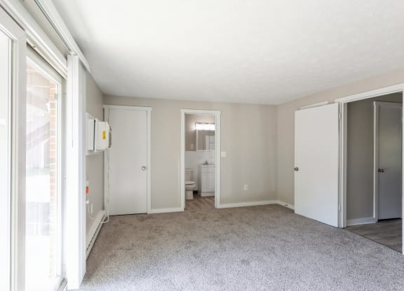 an empty living room with sliding glass doors to a bathroom at Stonebridge, Connecticut