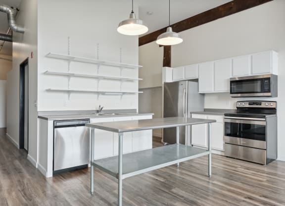 a kitchen with white cabinetry and stainless steel appliancesat Gaar Scott Historic Lofts, Minnesota, 55401