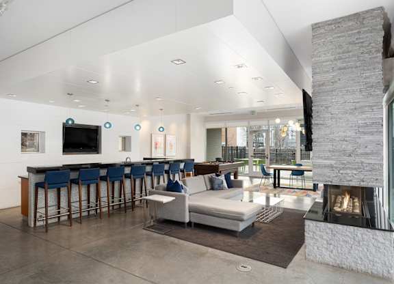 Posh Lounge Area With Fireplace In Clubhouse at Track 29 Apartments, Minnesota, 55408