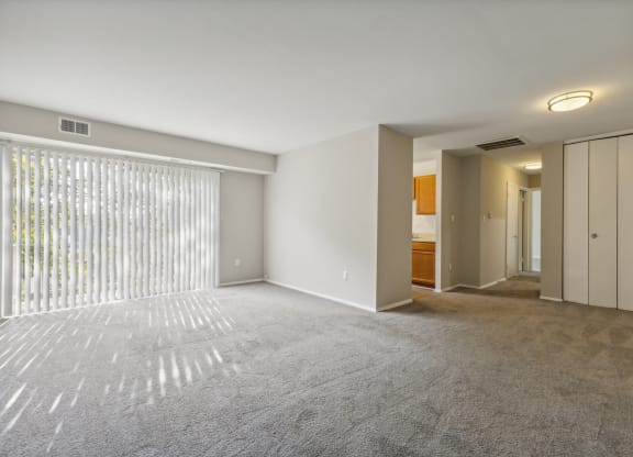 an empty living room with white walls and a large window at Briarwood Apartments, Virginia, 22026