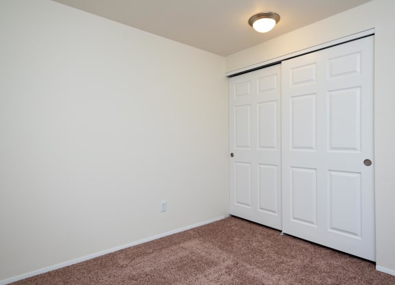 a bedroom with two closets and a carpeted floor at Murrayhill Park, Beaverton