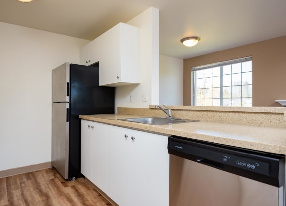 a kitchen with a sink and a black refrigerator at Murrayhill Park, Beaverton, 97008