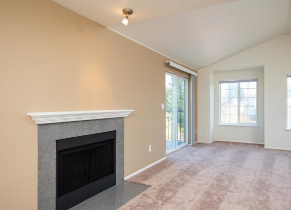 the living room has a fireplace and a door to the patio at Murrayhill Park, Oregon, 97008