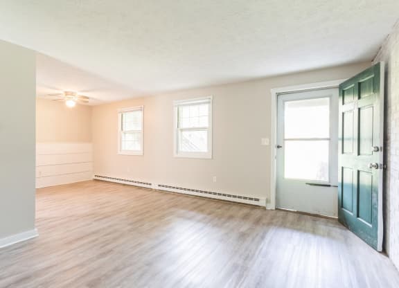 living room with wood floors and a green door at Stonebridge, Connecticut, 06029