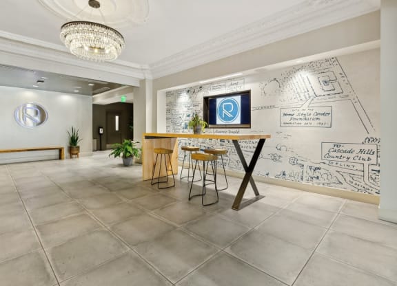 the lobby of a restaurant with a bar and graffiti on the wall at The Rowe, Grand Rapids, MI