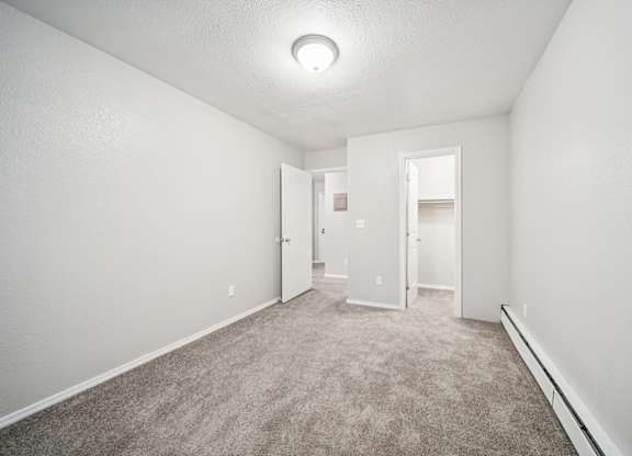 A white room with a carpeted floor and a ceiling light.