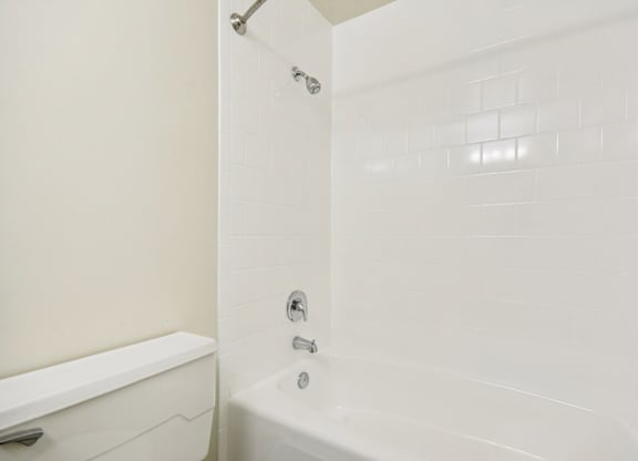 A white bathroom with a tub and shower.