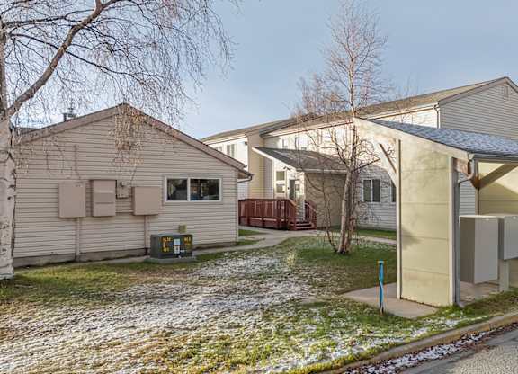 A house with a grey roof and a white fence.