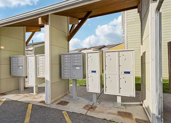 A row of utility boxes are lined up outside a building.