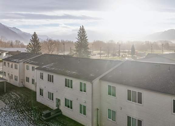 A view of a building with a mountain in the background.