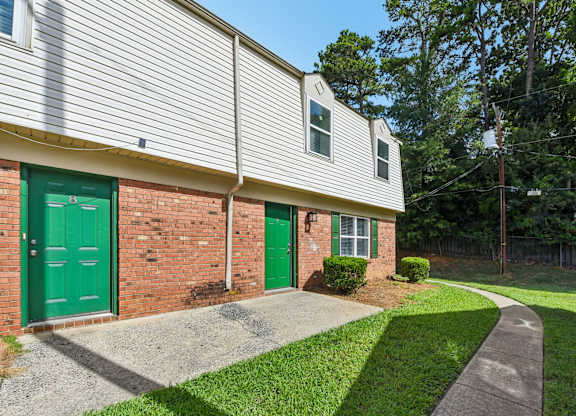 A building with a green door and a grey roof.