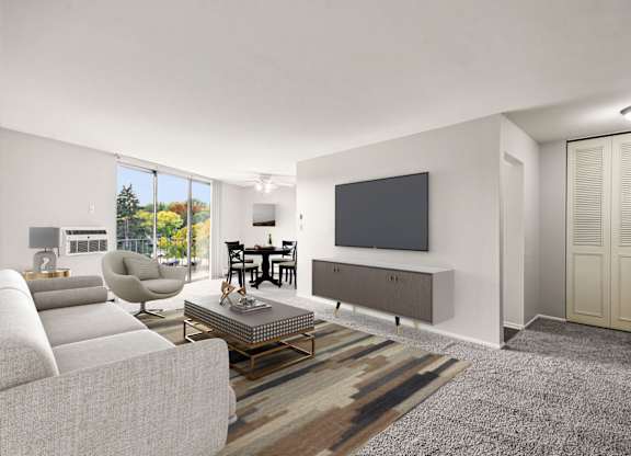 A modern living room with a grey sofa, a coffee table, a television, and a sliding door.