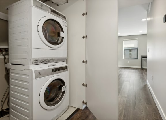 a washer and dryer stacked on top of each other in a laundry room at The Rowe, Grand Rapids, Michigan