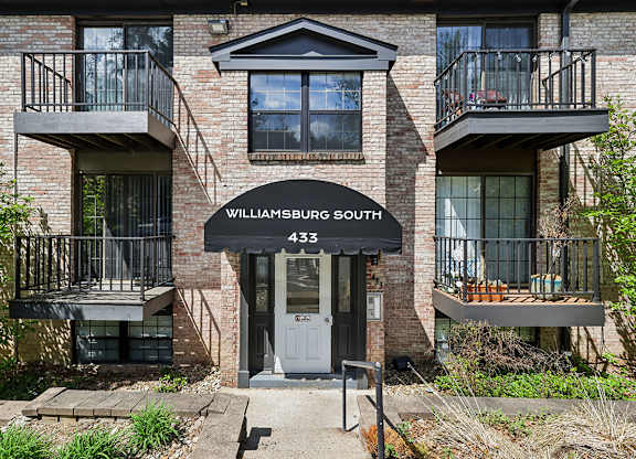 A brick building with a balcony and a door that says Williamsburg South 433.