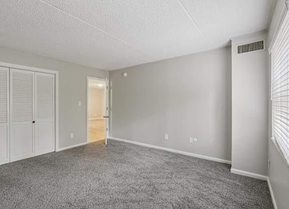 A room with a carpeted floor and white walls.