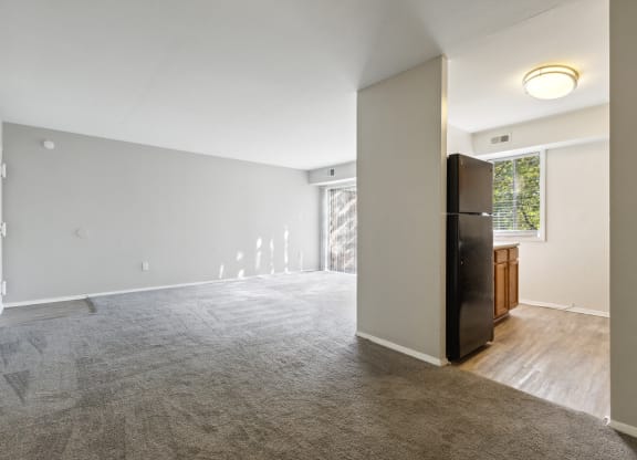 an empty living room with a refrigerator and a window at Briarwood Apartments, Dumfries