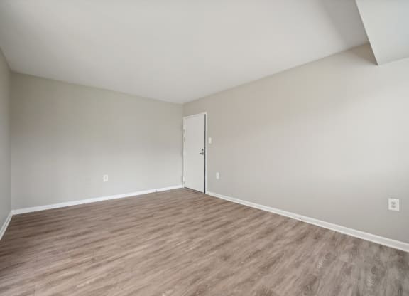 an empty room with white walls and wood flooring at ReNew Odenton