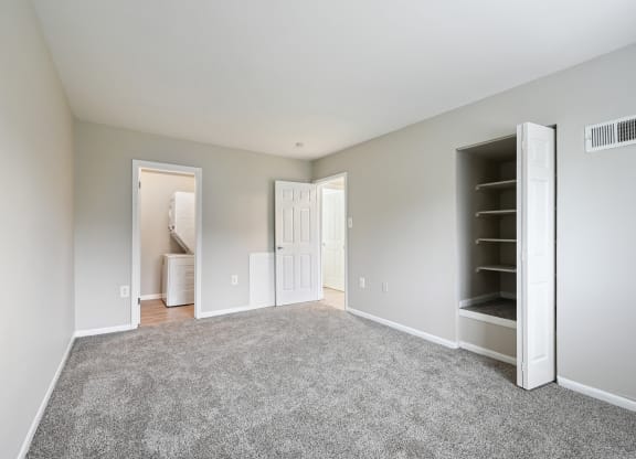 an empty bedroom with carpet and a closet at ReNew Odenton