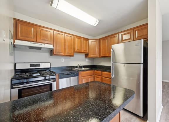 a kitchen with granite counter tops and stainless steel appliances at ReNew Odenton