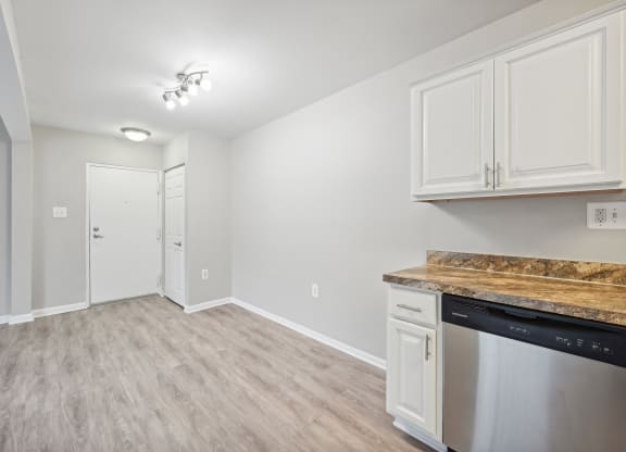 a kitchen and living room with white cabinets and a counter top at ReNew Odenton