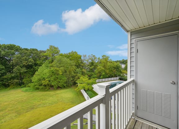 a view of the yard from the balcony of an apartment with a pool at ReNew Odenton