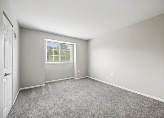 an empty room with carpet and a window at ReNew Odenton