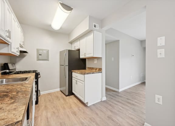 an open kitchen and living room with a stainless steel refrigerator at ReNew Odenton