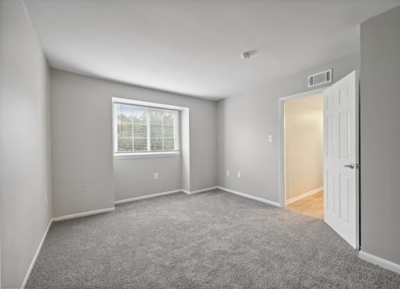 an empty room with a white door and a window at ReNew Odenton