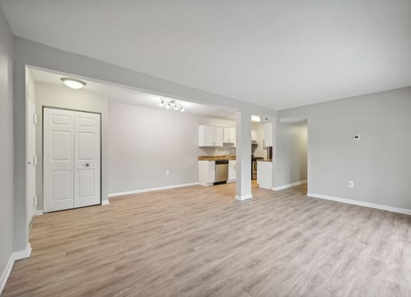 the living room and kitchen in a new home with wood flooring at ReNew Odenton