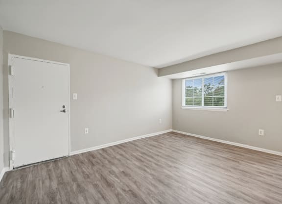 an empty bedroom with a door and a window at ReNew Odenton