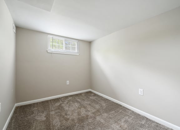 an empty room with carpet and a window at ReNew Odenton