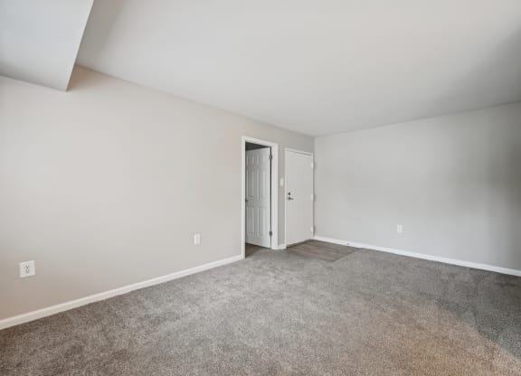 an empty room with carpet and a door to a closet at ReNew Odenton