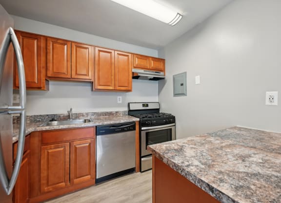 a kitchen with granite counter tops and stainless steel appliances at ReNew Odenton