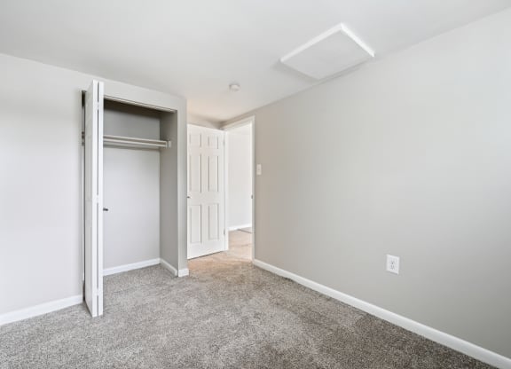 a bedroom with a closet and a door at ReNew Odenton