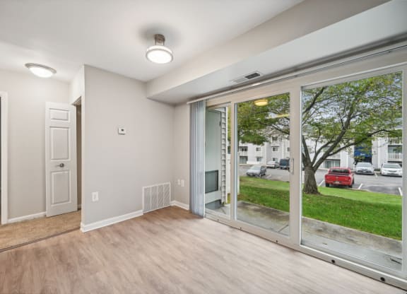 a living room with a large window and a door to the street at ReNew Odenton