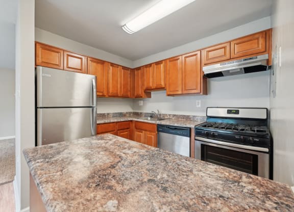 an updated kitchen with granite counter tops and stainless steel appliances at ReNew Odenton