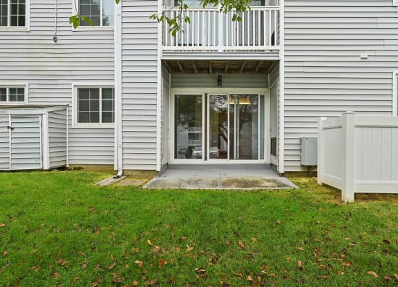 Exterior view into apartment building with patio and a balcony at ReNew Odenton