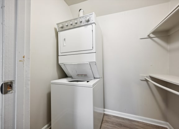 a white washer and dryer in a room with a white wall at ReNew Odenton