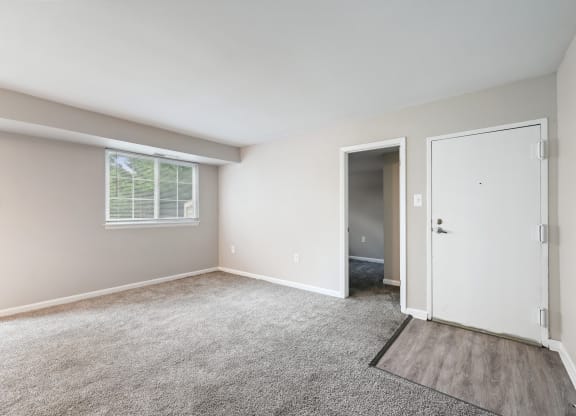 an empty room with carpet and a door at ReNew Odenton