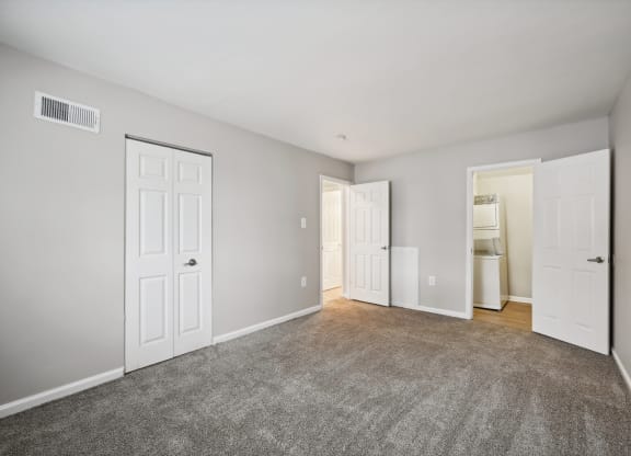 an empty room with white doors and a carpeted floor at ReNew Odenton