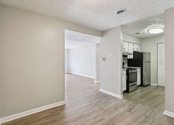 A kitchen area with a refrigerator, microwave, and oven.