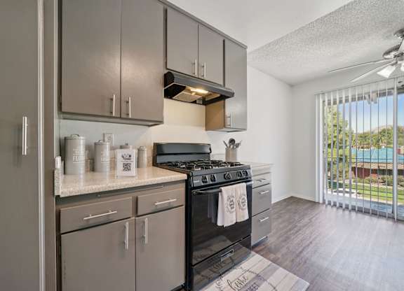 A modern kitchen with a black stove top oven.