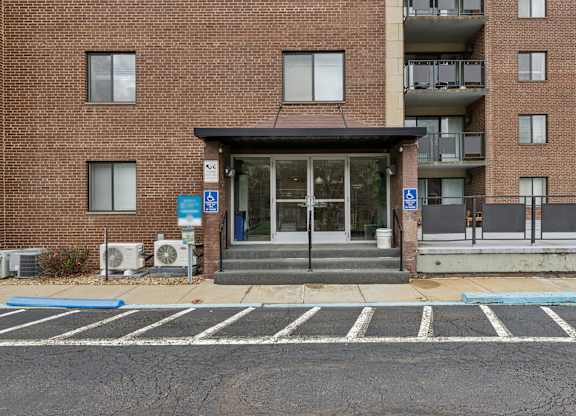 A brick building with a blue and white sign on the door.
