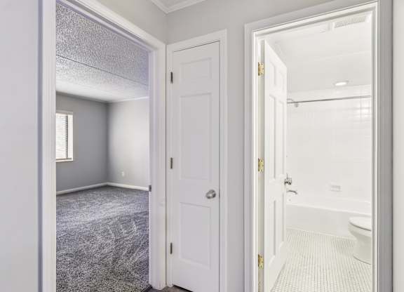 A bathroom with a toilet, sink, and bathtub is shown.