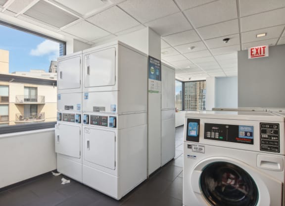 a laundry room with washing machines and dryers